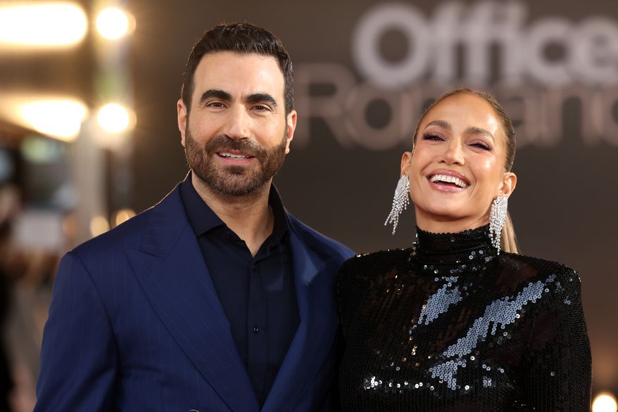 Brett Goldstein, left, and Jennifer Lopez pose for photographers upon arrival at the premiere of the film 'Office Romance' on Wednesday, June 3, 2026, in London. (Photo by Millie Turner/Invision/AP)