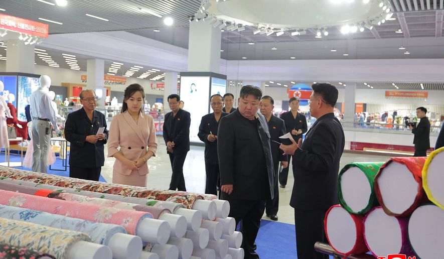 In this photo provided by the North Korean government, its leader Kim Jong Un, second right in front, and his daughter, second left, visit a garment and footwear exhibiion in Pyongyang, North Korea Monday, Oct. 19, 2026. Independent journalists were not given access to cover the event depicted in this image distributed by the North Korean government. The content of this image is as provided and cannot be independently verified. Korean language watermark on image as provided by source reads: "KCNA" which is the abbreviation for Korean Central News Agency. (Korean Central News Agency/Korea News Service via AP)