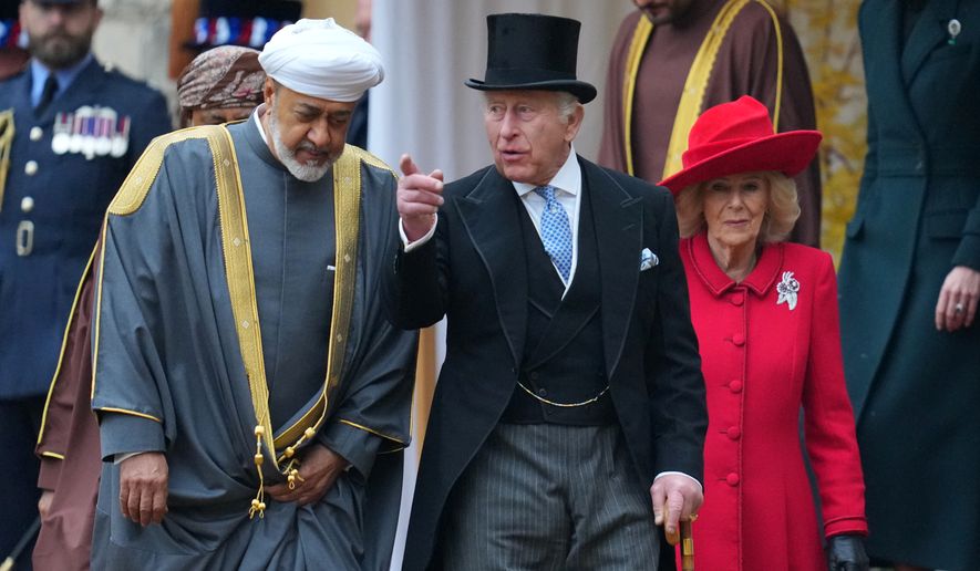 The Sultan of Oman, Haitham bin Tarik, Britain's King Charles III and Queen Camilla walk to review the Guard of Honour at Windsor Castle in Windsor, England, Tuesday, Oct. 20, 2026.(AP Photo/Kirsty Wigglesworth, Pool)