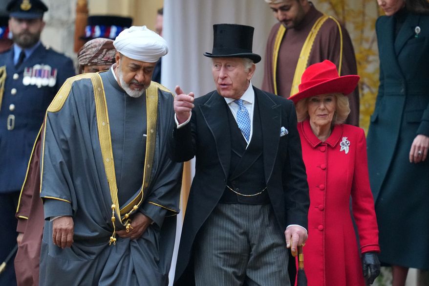 The Sultan of Oman, Haitham bin Tarik, Britain's King Charles III and Queen Camilla walk to review the Guard of Honour at Windsor Castle in Windsor, England, Tuesday, Oct. 20, 2026.(AP Photo/Kirsty Wigglesworth, Pool)