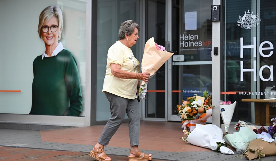 A woman delivers flowers at the electoral office of independent member of parliament, Helen Haines, in Wangaratta, Australia, Tuesday, Oct. 20, 2026. (James Ross/AAP Image via AP)
