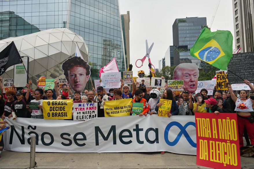 Demonstrators, holding a banner that reads in Portuguese "Meta do not interfere," rally against Meta over allegations of interference in Brazil's presidential election, outside Meta's headquarters in Sao Paulo, Monday, Oct. 19, 2026. (AP Photo/Andre Penner)
