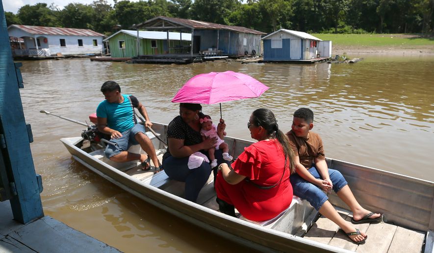 Voters arrive to a polling station during general elections in Iranduba, Brazil, Sunday, Oct. 4, 2026. (AP Photo/Edmar Barros)