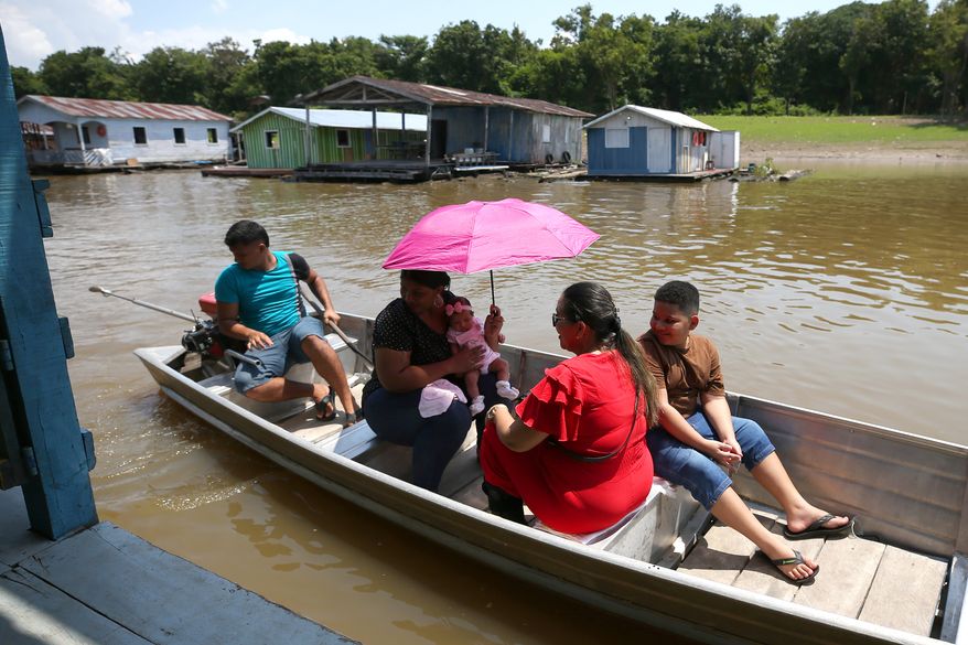 Voters arrive to a polling station during general elections in Iranduba, Brazil, Sunday, Oct. 4, 2026. (AP Photo/Edmar Barros)