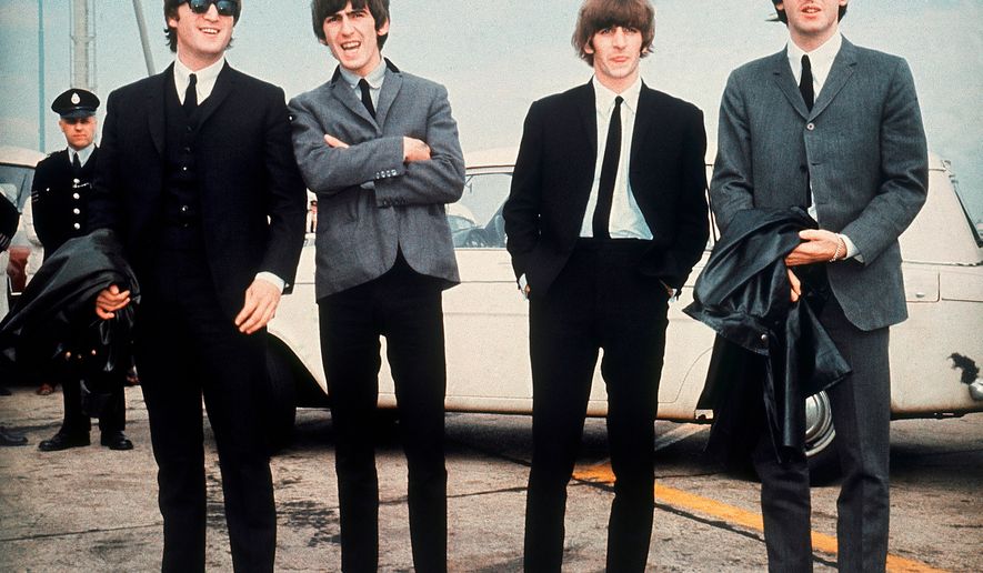 FILE - The Beatles, from left, John Lennon, George Harrison, Ringo Starr and Paul McCartney, arrive in Liverpool, England, on July 10, 1964, for the premiere of their movie "A Hard Day's Night." (AP Photo, File)