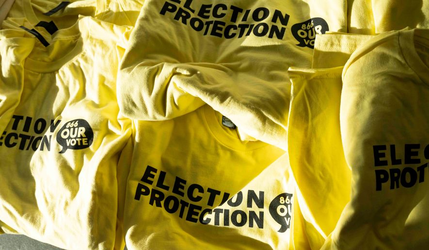 T-shirts are ready to be handed out to newly-trained poll chaplains and peacekeepers during a training, Tuesday, Oct. 6, 2026, ahead of the upcoming general midterm election, at Temple Chai in Scottsdale, Ariz. (AP Photo/Rebecca Noble)