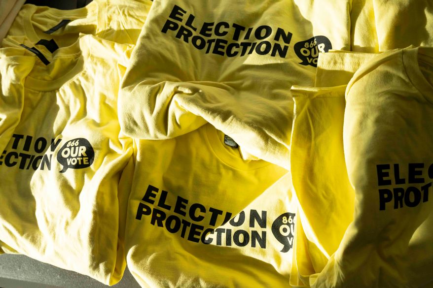 T-shirts are ready to be handed out to newly-trained poll chaplains and peacekeepers during a training, Tuesday, Oct. 6, 2026, ahead of the upcoming general midterm election, at Temple Chai in Scottsdale, Ariz. (AP Photo/Rebecca Noble)