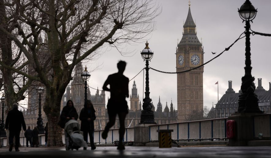 People walk on the banks of the Thames beside the Elizabeth Tower, known as Big Ben, and the Houses of Parliament in London, Wednesday, Feb. 11, 2026. (AP Photo/Kin Cheung, File)