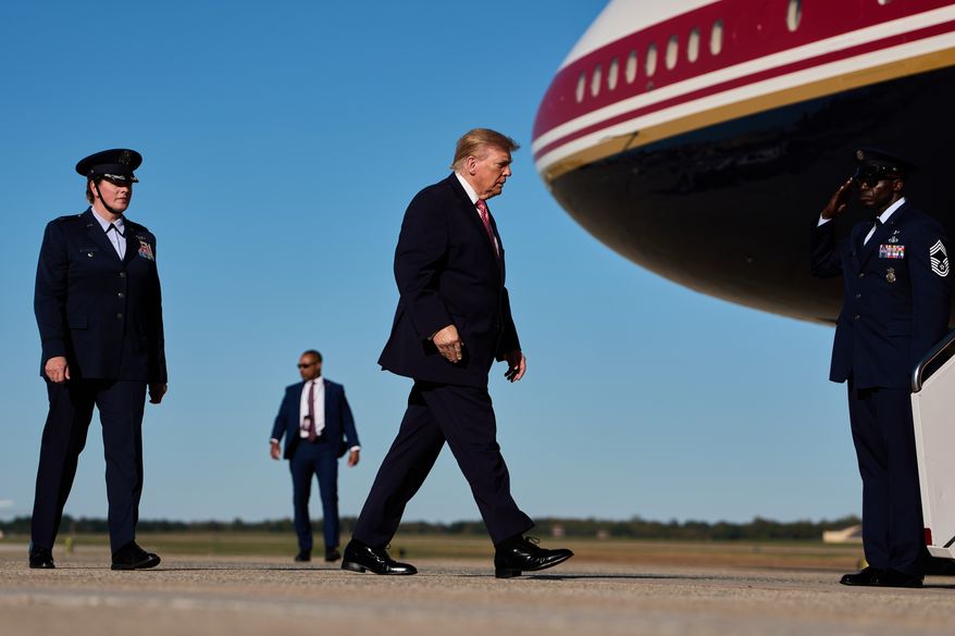 President Donald Trump walks from Marine One to board Air Force One, Monday, Oct. 19, 2026, at Joint Base Andrews, Md., with Col. Melissa Dombrock, deputy commander of the 89th Airlift Wing, left. (AP Photo/Julia Demaree Nikhinson, File)