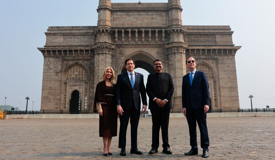 U.S. Secretary of State Marco Rubio, second left, and his wife Jeanette Dousdebes Rubio, left, pose for a photo with Maharashtra Chief Minister Devendra Fadnavis, third left, at the Gateway of India in Mumbai, India, Tuesday, Oct. 20, 2026. (Kylie Cooper/Pool Photo via AP)