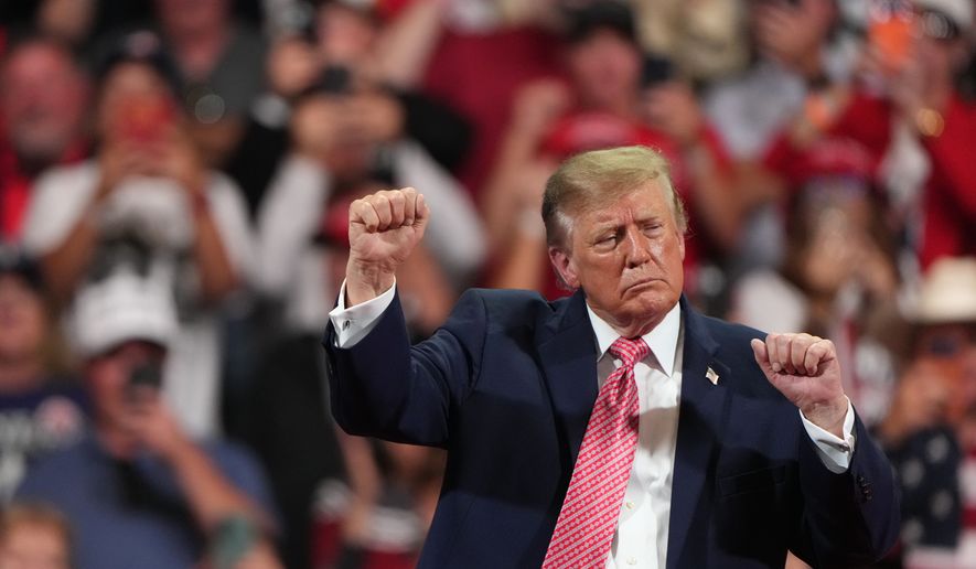 President Donald Trump dances at a campaign rally at Heartland Credit Union Arena, Monday, Oct. 19, 2026, in Park City, Kan. (AP Photo/Charlie Riedel)