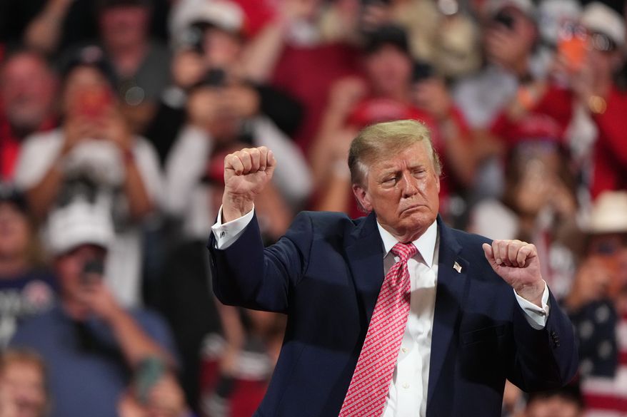 President Donald Trump dances at a campaign rally at Heartland Credit Union Arena, Monday, Oct. 19, 2026, in Park City, Kan. (AP Photo/Charlie Riedel)