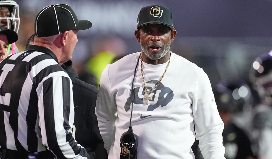 Colorado head coach Deion Sanders confers with referee in the first half of an NCAA college football game against Utah Saturday, Oct. 17 2026, in Boulder, Colo. (AP Photo/David Zalubowski)