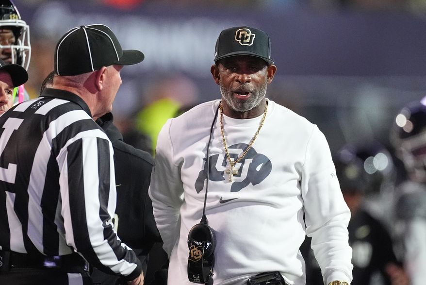 Colorado head coach Deion Sanders confers with referee in the first half of an NCAA college football game against Utah Saturday, Oct. 17 2026, in Boulder, Colo. (AP Photo/David Zalubowski)