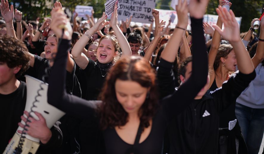 Protesters take part in a rally organized by teachers and students demanding improvements to education and measures to address the rising cost of living in Athens, Greece, Wednesday, Oct. 21, 2026. (AP Photo/Petros Giannakouris)