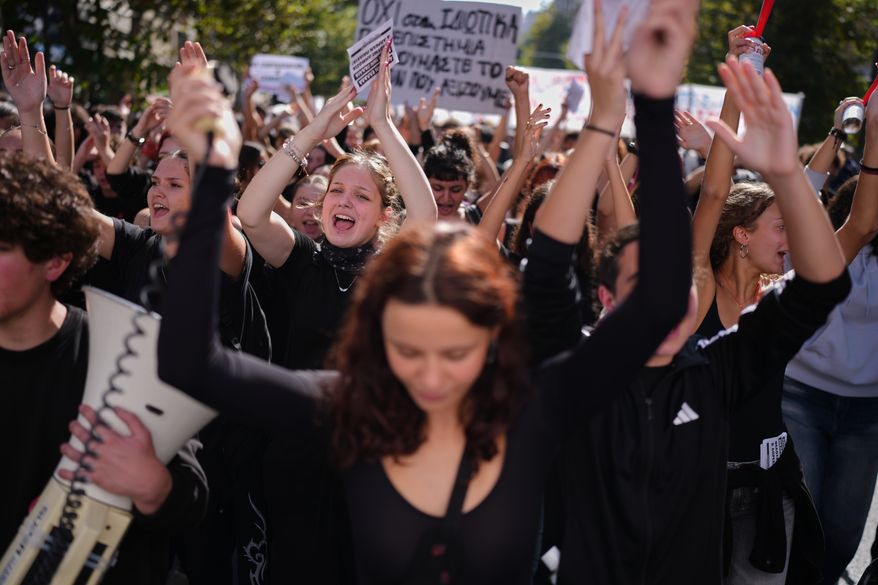 Protesters take part in a rally organized by teachers and students demanding improvements to education and measures to address the rising cost of living in Athens, Greece, Wednesday, Oct. 21, 2026. (AP Photo/Petros Giannakouris)
