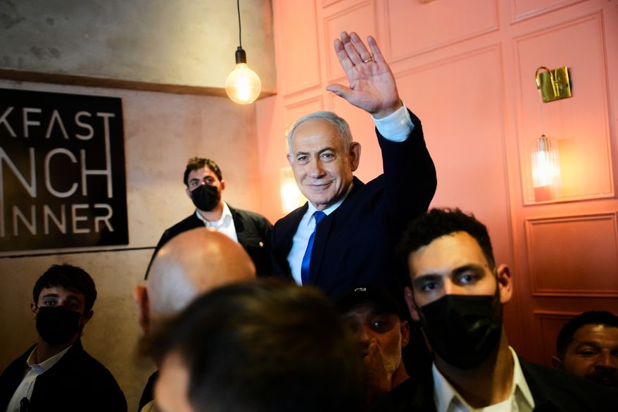 Israeli Prime Minister Benjamin Netanyahu, leader of the Likud party, waves to supporters during an election campaign in Dimona, southern Israel, Wednesday, Oct. 21, 2026. (AP Photo/Ohad Zwigenberg)