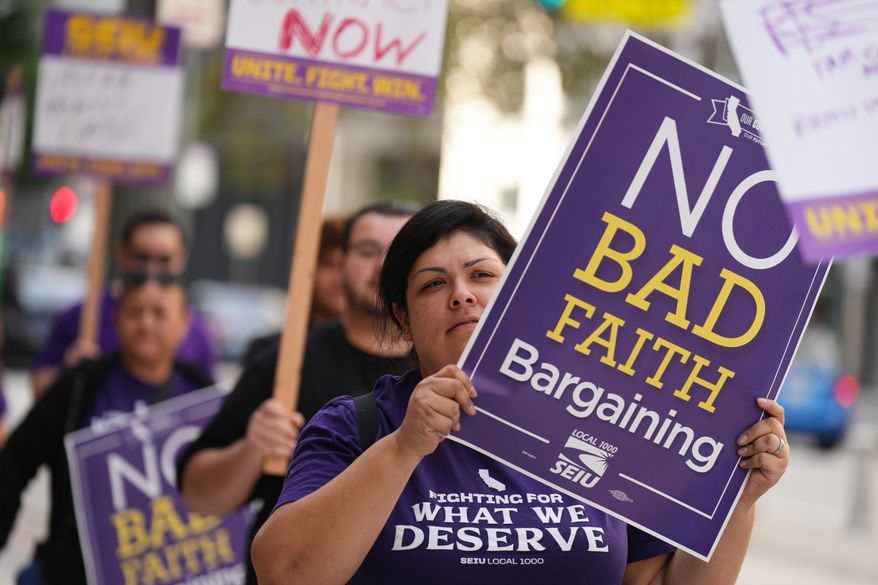 People protest in support of SEIU Local 1000 state workers during a one-day strike on Wednesday, Oct. 21, 2026, in Los Angeles. (AP Photo/Jae C. Hong)