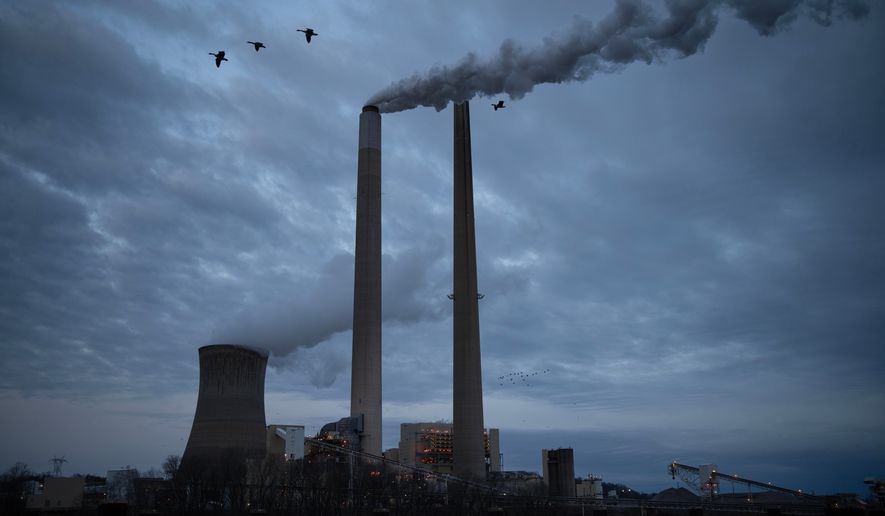 FILE - The coal-fired Mountaineer Power Plant, near New Haven, W.Va., operates across the Ohio River from the Lock 24 RV Park and Campground in Racine, Ohio, March 13, 2026. (AP Photo/Carolyn Kaster, File)