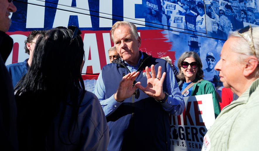 Republican nominee for U.S. Senate Mike Rogers speaks with supporters after a campaign event Wednesday, Oct. 21, 2026, in Sterling Heights, Mich. (AP Photo/Paul Sancya)
