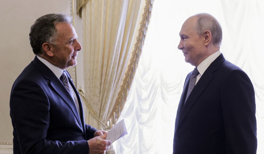 U.S. President Donald Trump's Special Envoy Steve Witkoff, left, holds a paper while speaking to Russian President Vladimir Putin at the Konstantin Palace in Strelnya, outside St. Petersburg, Russia, on Wednesday, Oct. 21, 2026. (Gavriil Grigorov, Sputnik, Kremlin Pool Photo via AP)