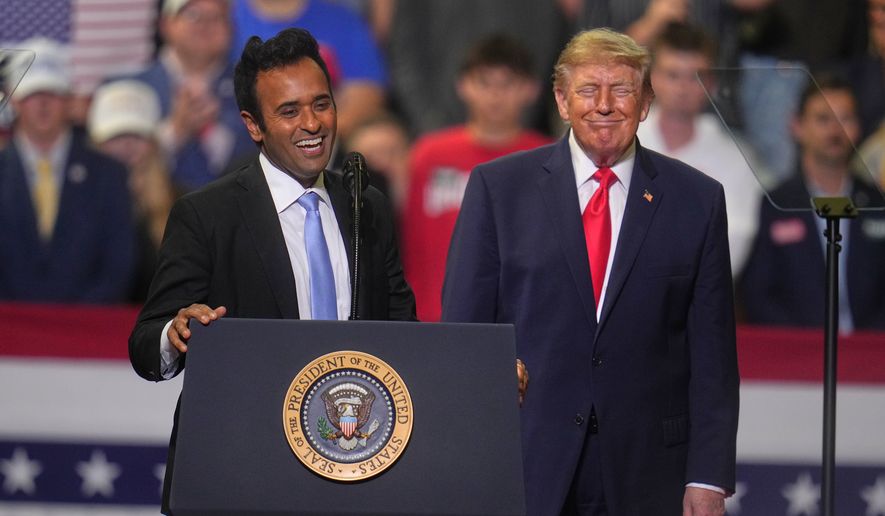 President Donald Trump listens a gubernatorial candidate Vivek Ramaswamy speaks at a campaign rally at the Covelli Centre, in Youngstown, Ohio, Monday, Oct. 12, 2026. (AP Photo/Gene J. Puskar)