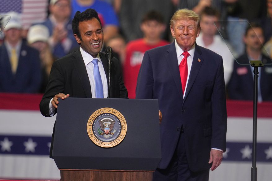 President Donald Trump listens a gubernatorial candidate Vivek Ramaswamy speaks at a campaign rally at the Covelli Centre, in Youngstown, Ohio, Monday, Oct. 12, 2026. (AP Photo/Gene J. Puskar)