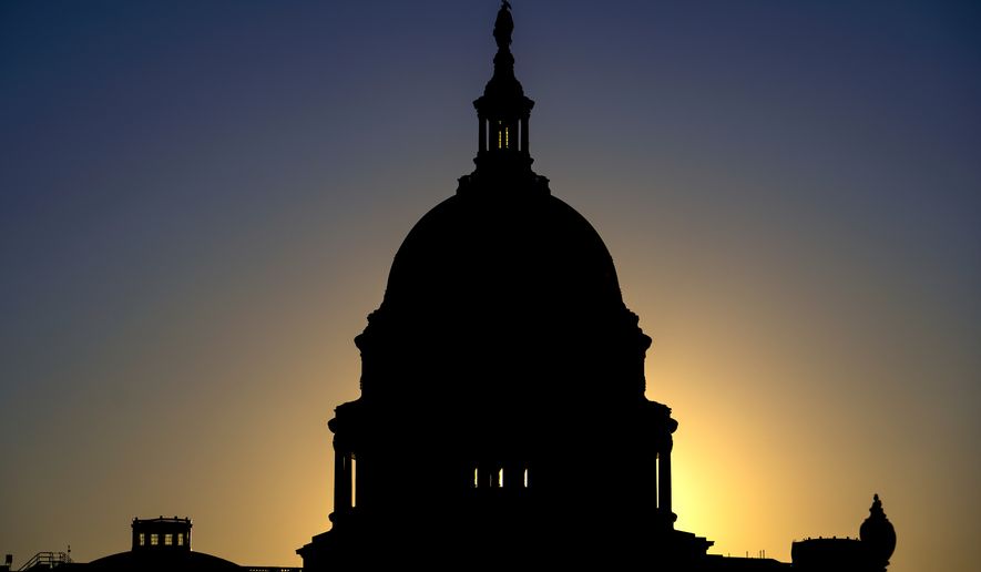 The sun rises behind the Capitol Dome in Washington, Tuesday, Oct. 20, 2026, two weeks before the midterm elections that will determine political control of Congress. (AP Photo/J. Scott Applewhite)