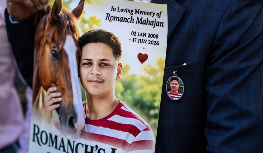 Gaurav Mahajan, uncle of Romanch Mahajan, holds a poster during a press conference ahead of the vote to ban horse carriages in Central Park, Thursday, Oct. 22, 2026, in New York. (AP Photo/Yuki Iwamura)