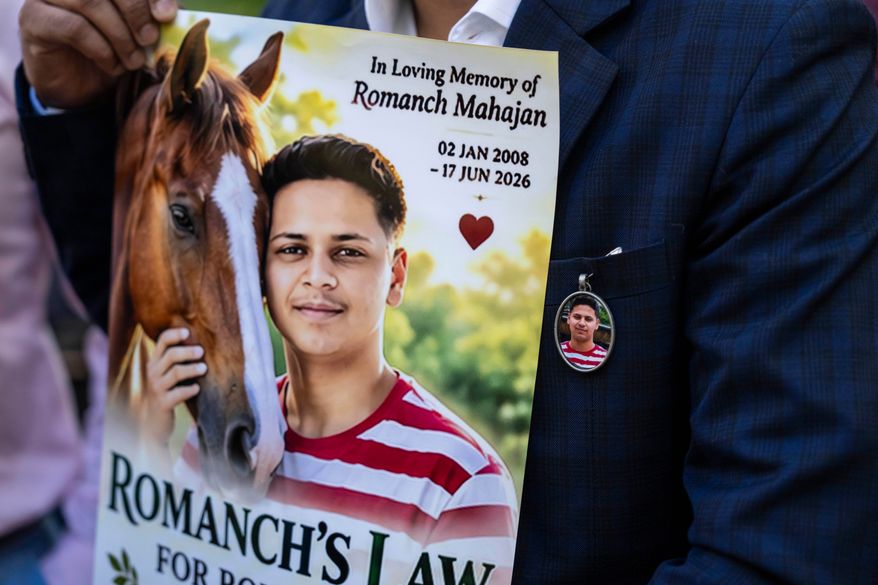 Gaurav Mahajan, uncle of Romanch Mahajan, holds a poster during a press conference ahead of the vote to ban horse carriages in Central Park, Thursday, Oct. 22, 2026, in New York. (AP Photo/Yuki Iwamura)