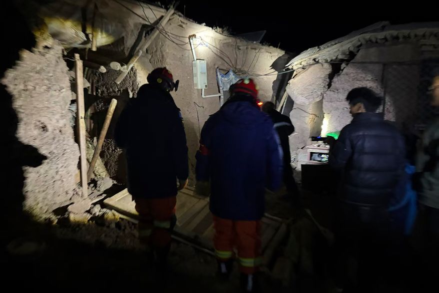 In this photo released by Xinhua News Agency, firefighters inspect an earthquake-hit village houses in Baqen County of Nagqu City in China's Tibet autonomous region, on Friday, Oct. 23, 2026. (Xinhua via AP)