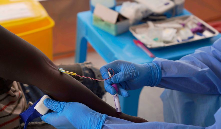 A doctor collects an participant's to test during clinical trials attempting to stop the rare Bundibugyo virus, amidst a deadly Ebola outbreak, in Rwampara Hospital in Ituri, Congo, Thursday, Oct. 1, 2026. (AP Photo/Dieudonne Dirole)