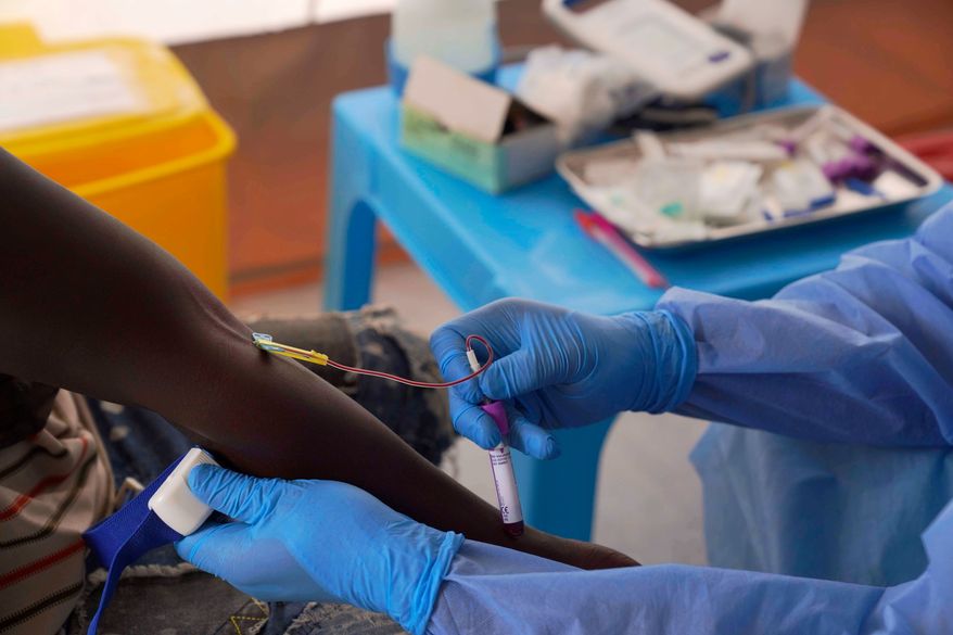 A doctor collects an participant's to test during clinical trials attempting to stop the rare Bundibugyo virus, amidst a deadly Ebola outbreak, in Rwampara Hospital in Ituri, Congo, Thursday, Oct. 1, 2026. (AP Photo/Dieudonne Dirole)