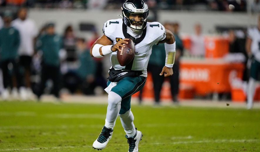 Philadelphia Eagles quarterback Jalen Hurts (1) runs the ball during the first half of an NFL football game against the Chicago Bears in Chicago, Monday, Sept. 28, 2026. (AP Photo/Nam Y. Huh)
