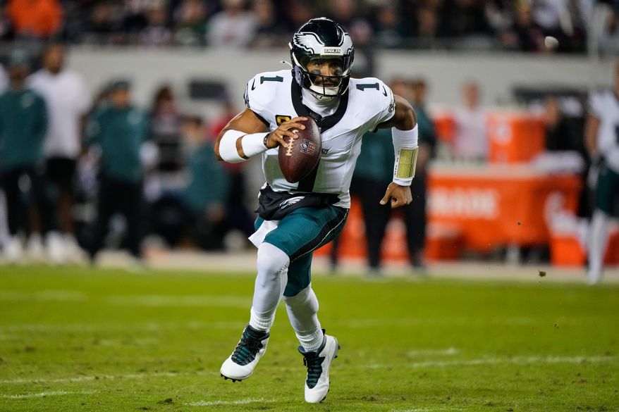 Philadelphia Eagles quarterback Jalen Hurts (1) runs the ball during the first half of an NFL football game against the Chicago Bears in Chicago, Monday, Sept. 28, 2026. (AP Photo/Nam Y. Huh)