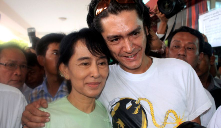 FILE- Myanmar democracy icon Aung San Suu Kyi and her son Kim Aris pose for a photo at Bagan airport before leaving for Yangon, July 8, 2011. (AP Photo/Khin Maung Win, File)