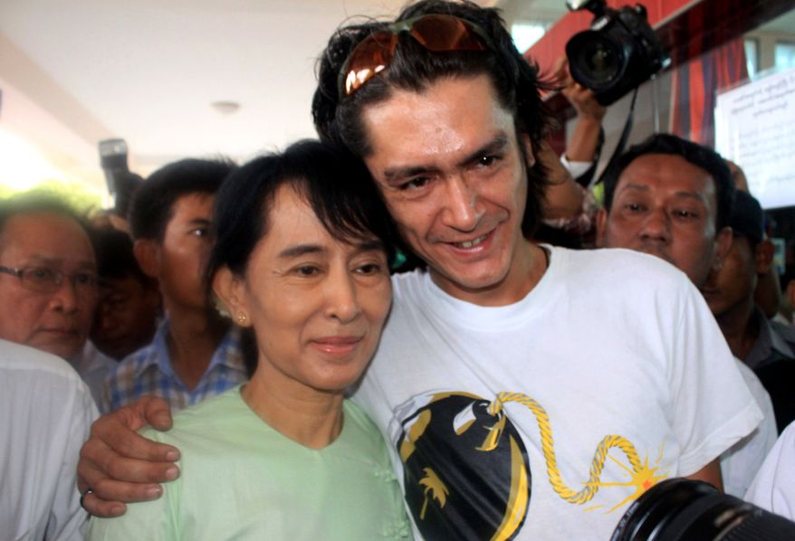 FILE- Myanmar democracy icon Aung San Suu Kyi and her son Kim Aris pose for a photo at Bagan airport before leaving for Yangon, July 8, 2011. (AP Photo/Khin Maung Win, File)