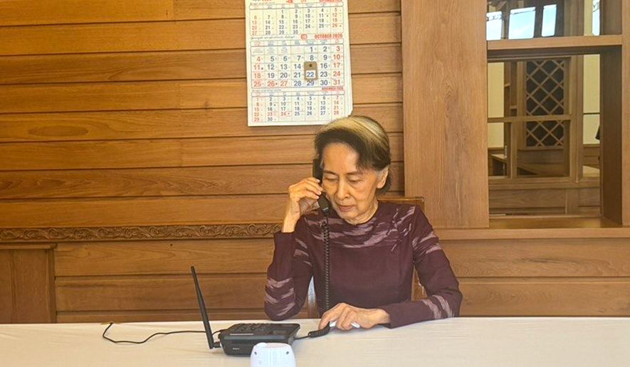In this photo released by Myanmar President Spokesperson Office on Thursday, Oct.22, 2026, Myanmar ousted leader Aung San Suu Kyi talks on the phone with her son Kim Aris, in Naypyitaw, Myanmar. (Myanmar President Spokesperson Office via AP)