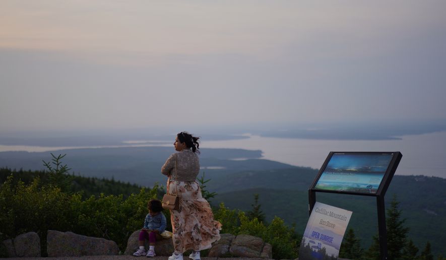 Visitors at the summit of Cadillac Mountain in Acadia National Park in Maine, on Tuesday, July 1, 2026. (AP Photo/Jessie Wardarski)
