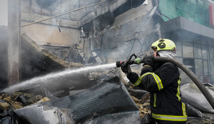 A firefighter tries to extinguish a fire after a Russian missile attack in central Kyiv, Ukraine, Thursday, Oct. 22, 2026. (AP Photo/Efrem Lukatsky)