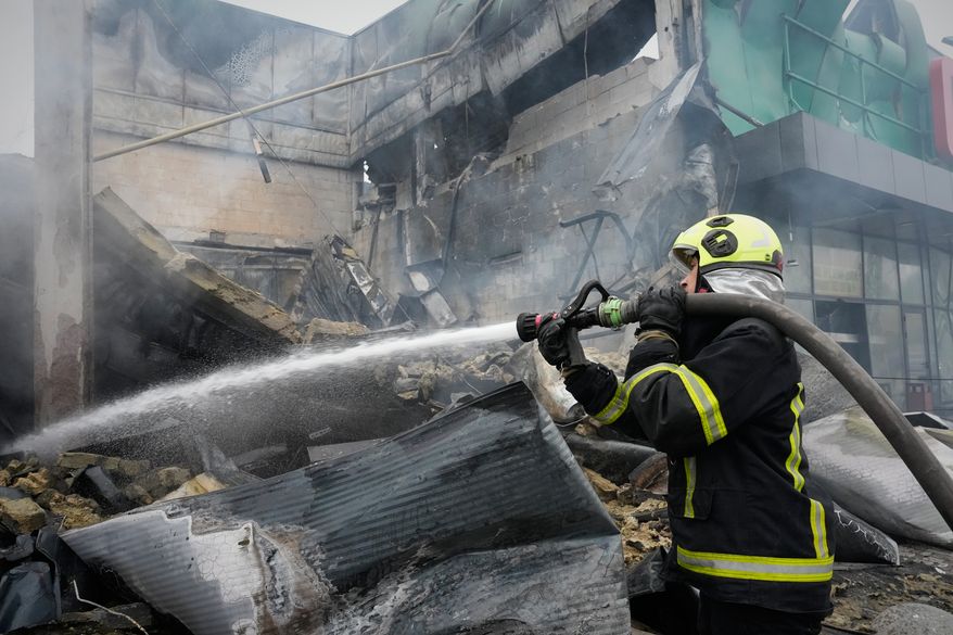 A firefighter tries to extinguish a fire after a Russian missile attack in central Kyiv, Ukraine, Thursday, Oct. 22, 2026. (AP Photo/Efrem Lukatsky)