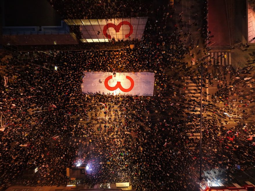 People take part in the final "Student List – Students Win" rally ahead of a parliamentary election in Belgrade, Serbia, Thursday, Oct. 22, 2026. (AP Photo/Armin Durgut)