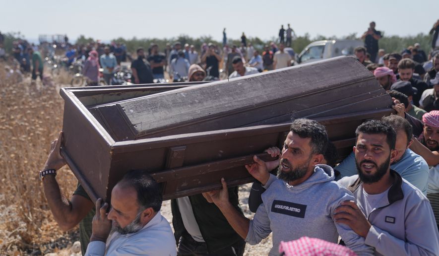 Mourners carry the coffin of Muath Salama al-Baeer, a young man with a disability who state media said was killed during an early morning Israeli military incursion, during his funeral in Jamla, in the Yarmouk Basin area of western Daraa province, Syria, Thursday, Oct. 22, 2026. (AP Photo/Ghaith Alsayed)