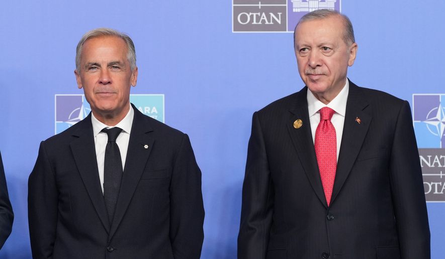 FILE - Canada's Prime Minister Mark Carney, left, and Turkish President Recep Tayyip Erdogan pose for a photo during the NATO summit in Ankara, Turkey, Wednesday, July 8, 2026. (AP Photo/Alex Brandon, File)