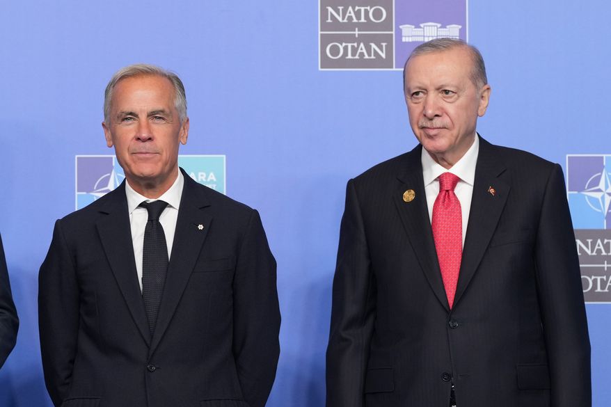 FILE - Canada's Prime Minister Mark Carney, left, and Turkish President Recep Tayyip Erdogan pose for a photo during the NATO summit in Ankara, Turkey, Wednesday, July 8, 2026. (AP Photo/Alex Brandon, File)