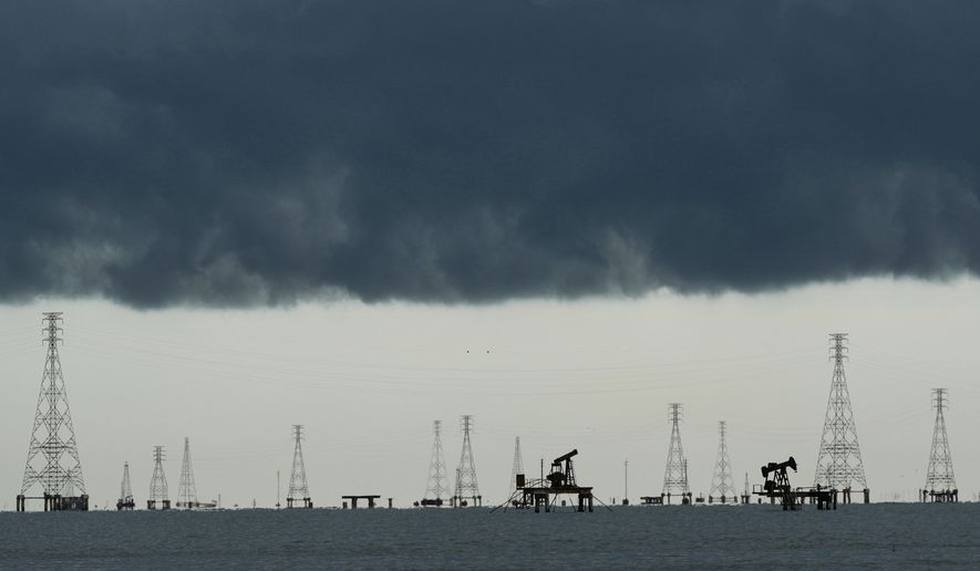 FILE - Clouds form over pumpjacks and power transmission towers on Lake Maracaibo in Cabimas, Venezuela, Sept. 1, 2026. (AP Photo/Ariana Cubillos, File)