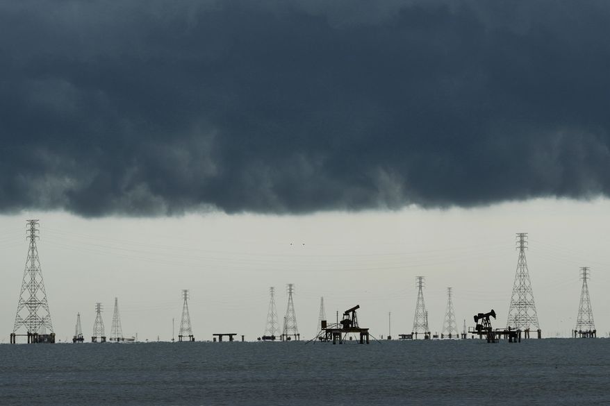 FILE - Clouds form over pumpjacks and power transmission towers on Lake Maracaibo in Cabimas, Venezuela, Sept. 1, 2026. (AP Photo/Ariana Cubillos, File)