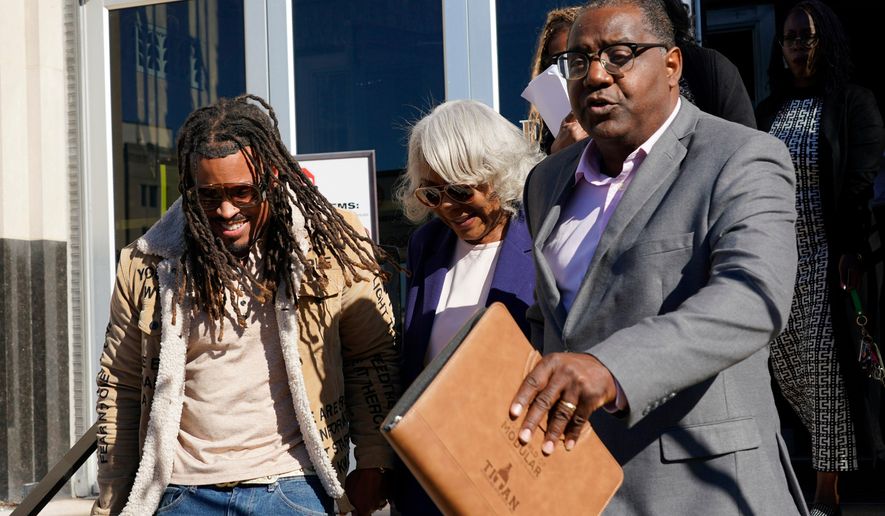 Virginia State Sen. Louise Lucas, D-Portsmouth, center, is led to a waiting vehicle as she leaves federal court. Thursday Oct. 22, 2026, in Norfolk, Va. (AP Photo/Steve Helber)
