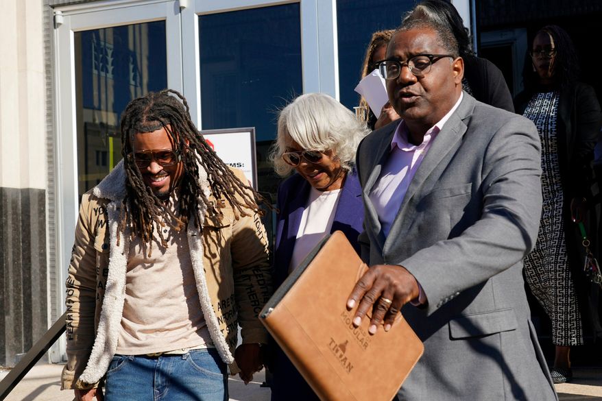Virginia State Sen. Louise Lucas, D-Portsmouth, center, is led to a waiting vehicle as she leaves federal court. Thursday Oct. 22, 2026, in Norfolk, Va. (AP Photo/Steve Helber)