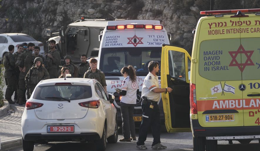 Israeli soldiers and emergency personnel gather near ambulances following a shooting attack near Yehuda Junction, near Hebron, in the occupied West Bank, Friday, Oct. 23, 2026. (AP Photo/Mahmoud Illean)